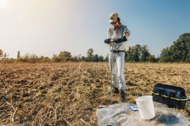 Soil Sampling. Woman Agronomist Taking Sample With Soil Probe Sa